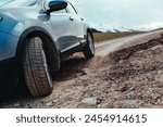 Car driving on bumpy road after landslide in the mountains