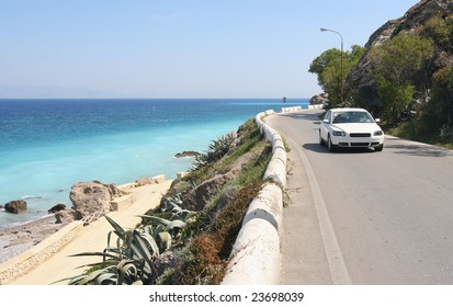 Car Driving On A Coastal Road Along The Mediterranean Sea