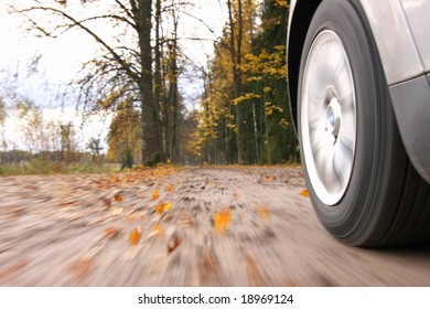 Car Driving On Country Road. Autumn Scene, Low Angle, Motion Blur.