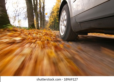 Car Driving On Country Road. Autumn Scene, Low Angle, Motion Blur.