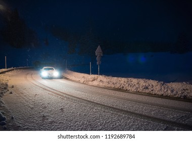 Car Driving On Dangerous Road At Night With Fresh Snow