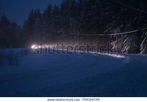 Car driving on dark
road at bad weather.