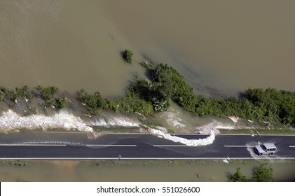 Car Driving On Flooded Road