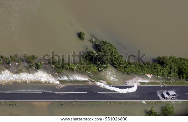 Car driving on flooded\
road
