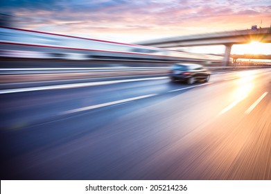 Car Driving On Freeway At Sunset, Motion Blur