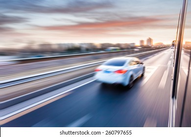 Car Driving On Freeway At Sunset, Motion Blur