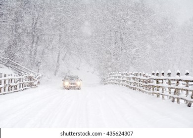Car driving on a heavy winter road