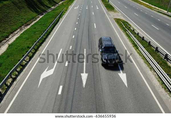 The car is\
driving on the highway in a sunny\
day