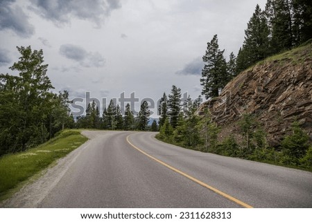Car driving on a mountain road in the Canadian Rockies.  in Banff National Park, Alberta, Canada,Montain scenic landscape. Tourism in summer