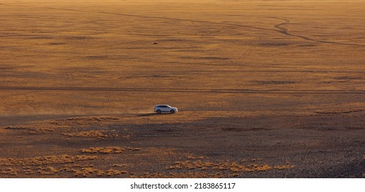 Car driving on offroad sand in Gobi desert in Mongolia, top view. - Powered by Shutterstock