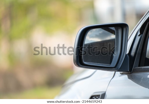 Car driving on the road. Blur Reflection in a\
car mirror.Rear view mirror reflection.Close up of car mirror with\
reflection of behind the\
car.