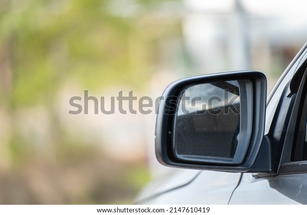 Car driving on the road. Blur Reflection in a\
car mirror.Rear view mirror reflection.Close up of car mirror with\
reflection of behind the\
car.