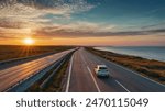 Car driving on the road in summer. highway landscape at colorful sunset. coastal road in europe. summer trip on the road on beautiful nature scenery. highway view on ocean beach.