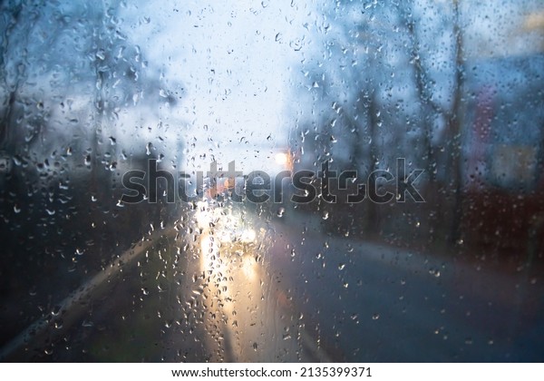 CAR DRIVING ON THE WET ROAD AT RAINY WEATHER,
SAFE TRANSPORTATION
BACKGROUND