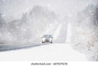 The Car Is Driving On A Winter Road In A Blizzard