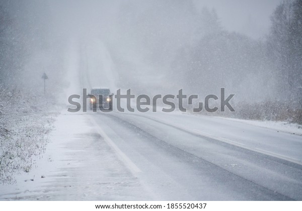 Car is driving
on a winter road in a
blizzard