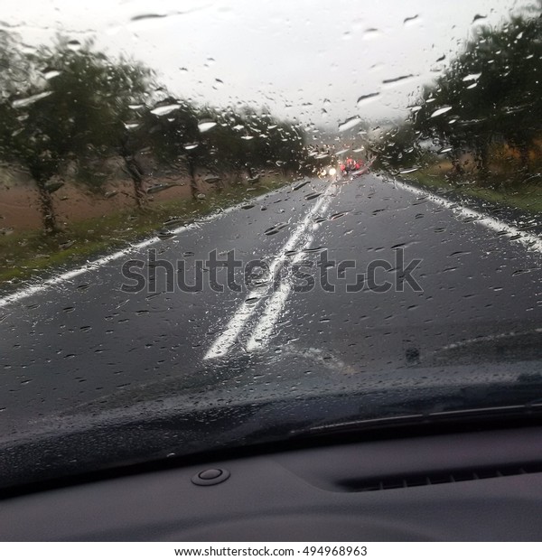 car driving in\
rain