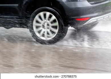 car driving in the rain on a wet road. danger of aqua planning and accidents