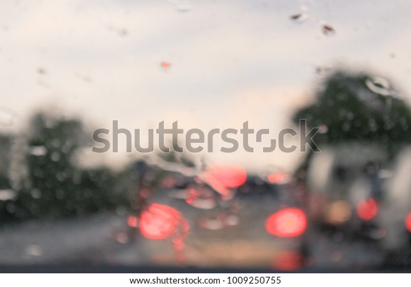 Car\
driving in a rain storm background.traffic\
jam