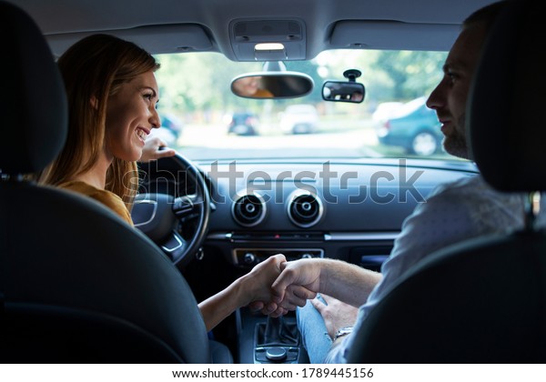 Car driving school. Shot\
of student driver and instructor handshake before first lesson of\
driving.