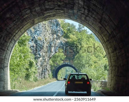 Car driving , in the tunnel. Arch frames. Asphalt road. 