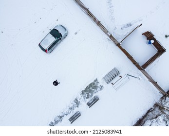 Car And Drone Pilot At The Gate. View From The Drone From Above. Winter