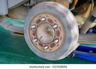 Car drum break detail and car jack with tire removed - Shutterstock ID 1927658096