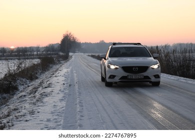 car during the sunset. polish nature arround, frost, snow and ice.