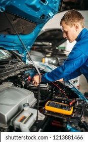 Car Electrician Checks The Battery Level