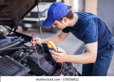 Car Electrician Troubleshooting A Car Engine