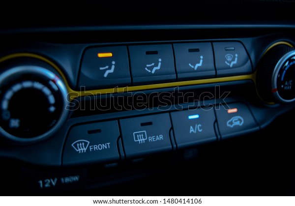 Car electronic Air and heat control dials with yellow\
stripe. 