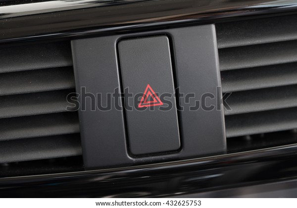 Car
emergency attention light button in red
triangle