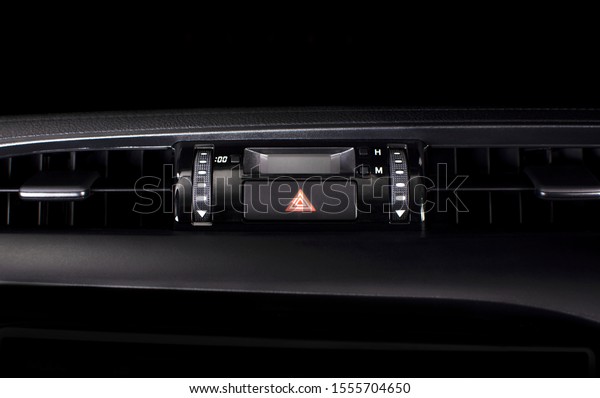 Car emergency light
button in a car.