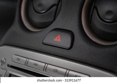 Car Emergency Lights Button On Dashboard (close Up With Dark And Light)