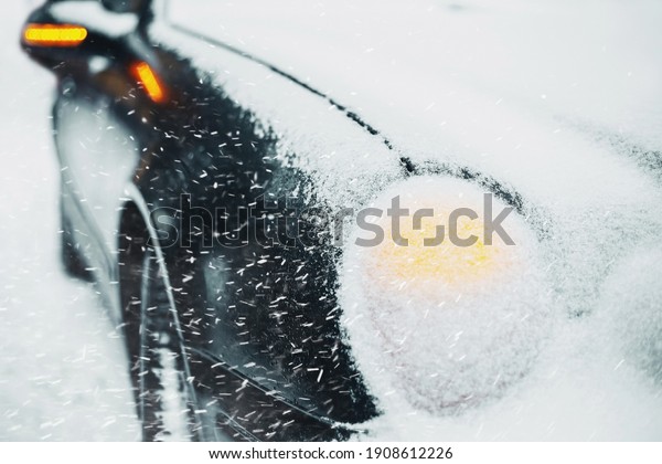 Car emergency situation hazard\
warning lights on bad winter weather severe blizzard and\
frost