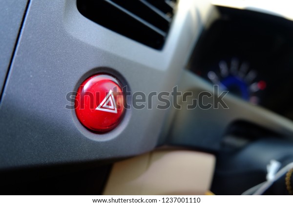 car
emergency warning light button in front car
console