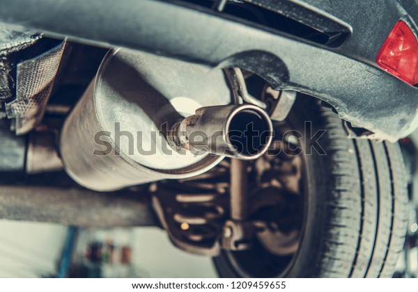 Car Emission Test Theme. Modern Compact Car
Muffler Closeup.