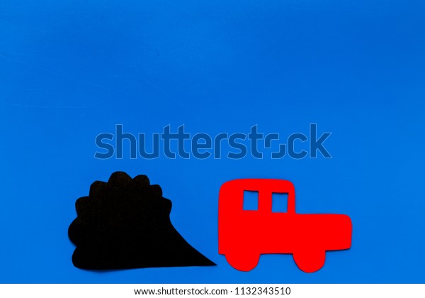 Car emitting dirty\
smoke. Pollution concept. Car and smoke cutout on blue background\
top view copy space