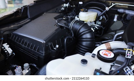Car engine air filter box. Black plastic box with pipes for air filters and engine parts in the engine compartment. Selective focus
