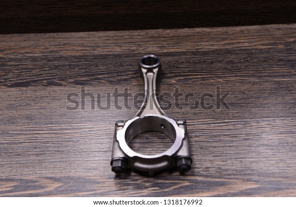 Car engine\
connecting rod wooden\
background