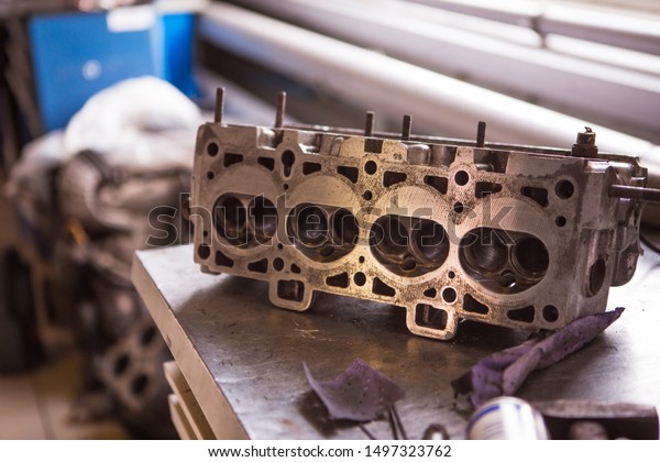Car engine\
disassembled separately from the machine. The process of repairing\
the engine in the service\
station.