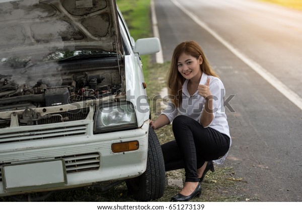 Car engine failure,\
stressed young woman