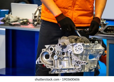Car engine in front of a car mechanic. Locksmith repairs a car engine. New dull engine of a auto in a automobile repair shop. Auto mechanic examines it for problems. Concept - motor overhaul.