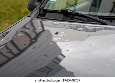 Car Engine Hood With Many Hail Damage Dents Show The Forces Of Nature And The Importance Of Car Insurance And A Replacement Value Insurance Against Hail Storm And Storm Hazards Or Extreme Weather