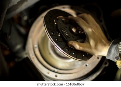 Car Engine Maintenance. Engine Clutch Repair. Hands With A Mechanic With A Clutch Disc.