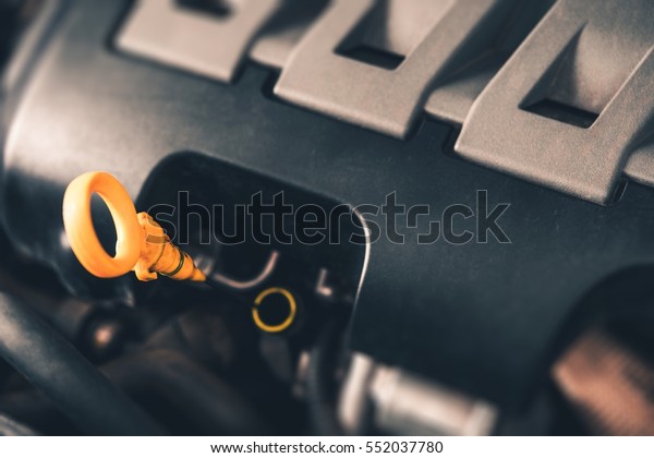 Car Engine Oil Check Photo Concept. Modern Car\
Engine Closeup on Dipstick