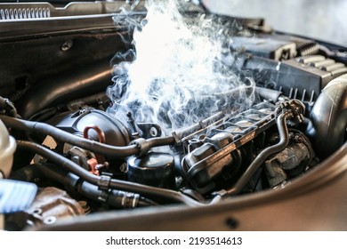 car engine overheating close up. vehicle engine in smoke. smoke or steam from a vehicle engine