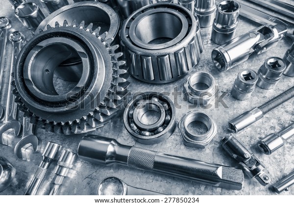 Car engine parts on\
metal background