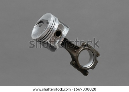 Car engine piston isolated on gray background.