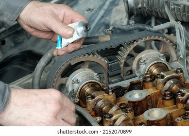 Car Engine Repair In A Car Service Center. Applying A Sealant When Replacing The Valve Cover Gasket. The Cylinder Head Of The Internal Combustion Engine.